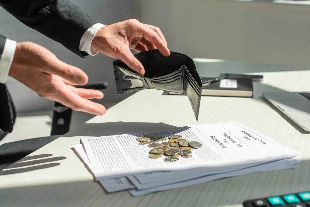 Cropped view of businessman holding an empty wallet representing financial hardship and asset protection in bankruptcy