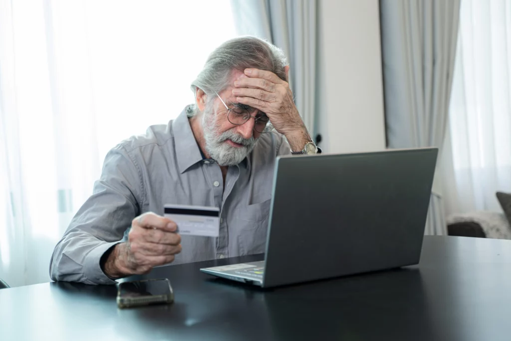 Worried man reviewing credit card debt and bankruptcy options in Kentucky