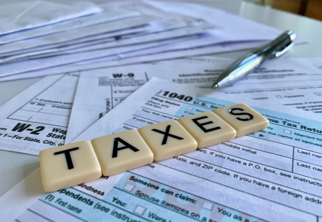 Taxes spelled on tax return forms representing whether bankruptcy can clear tax debt in Kentucky